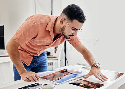 Buy stock photo Photographer person looking at photos for photography portfolio, photoshoot results thinking, decision and choice. Professional designer or serious man analysis of images on desk for print catalog