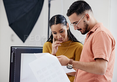 Buy stock photo Photographers, man and woman with documents, review and satisfaction in studio, happy and art creativity. Photography, employees and coworkers with paperwork, happiness and teamwork with results