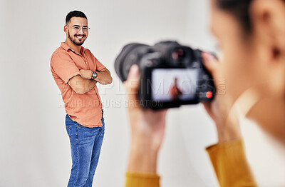 Buy stock photo Shooting, photography and photographer with man model in studio for creative, advertising and image. Media, backstage and professional woman videographer with guy, camera and equipment for photoshoot