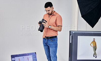 Serious, photographer and man on camera in studio for shoot, magazine project or online content. Backstage or male thinking for digital profession, fashion web design or creative internet catalog