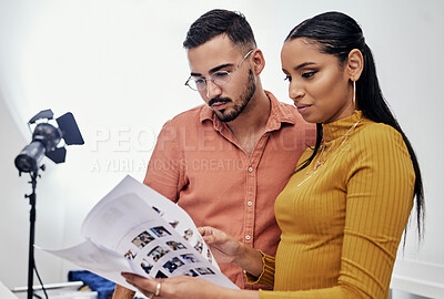 Buy stock photo Documents, teamwork or planning with a photographer and model talking in a studio for creative production. Collaboration, designer or fashion with a designer man and woman at work on a magazine shoot