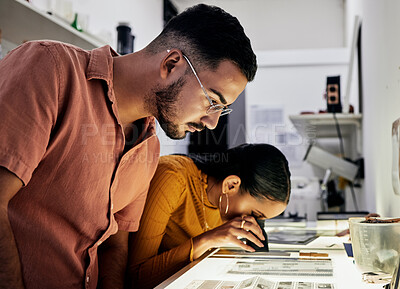 Buy stock photo Photographer, editing and film negatives with looking, magnifying glass for zoom analysis at photo journalist job. Photography man, analyse or focus with woman in studio for creative decision in team