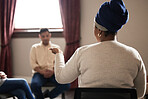 Support, black woman and group of people in therapy with understanding, sharing feelings and talking in session. Mental health, addiction or depression, men and women with therapist sitting together.