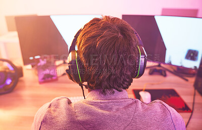 Buy stock photo Back of man, streamer and video game on computer in home, desk or online games of virtual competition. Geek gamer, live streaming and gaming with headphones in neon lighting, esports tech or gen z 