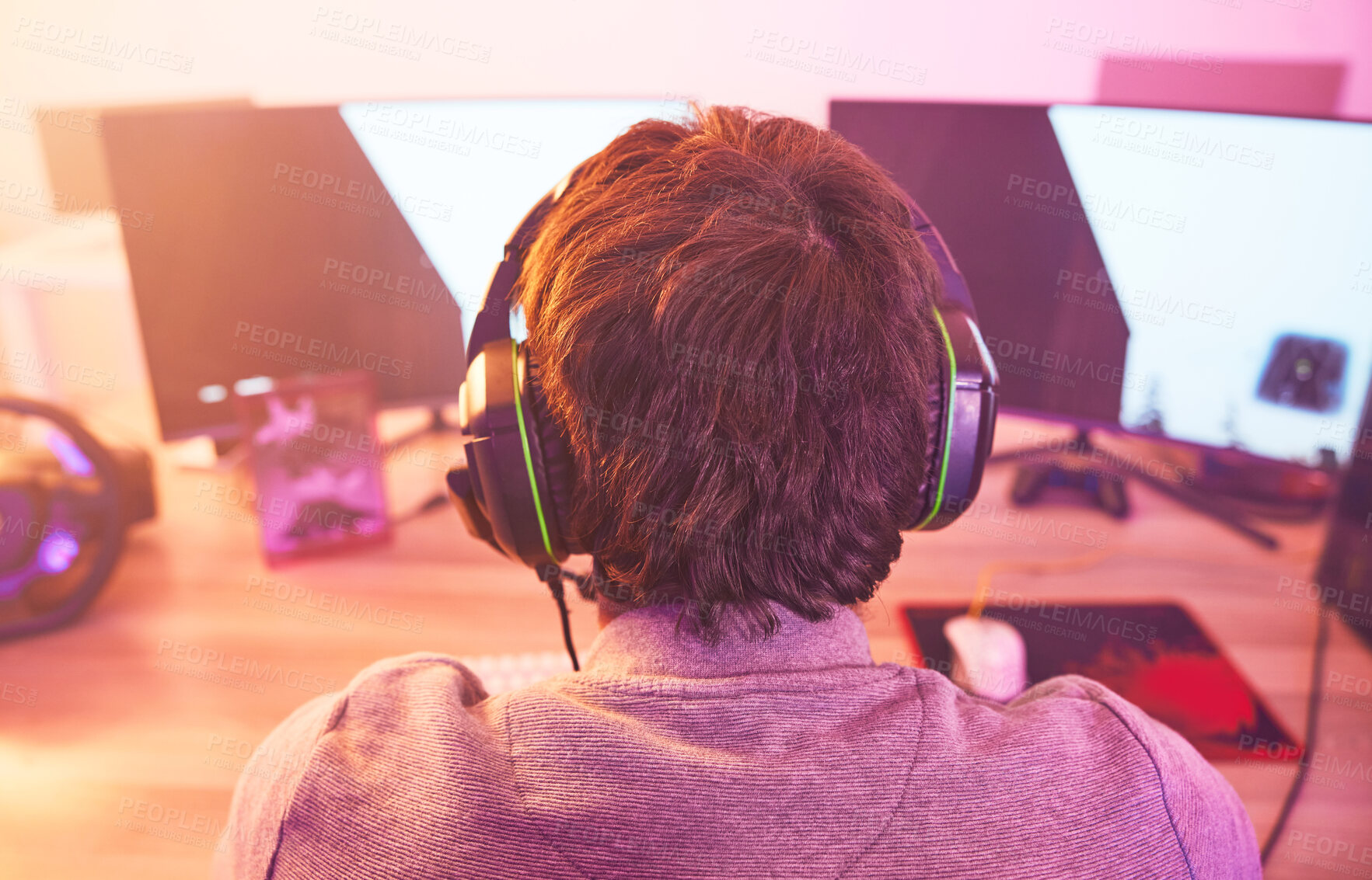 Buy stock photo Back of man, streamer and video game on computer in home, desk or online games of virtual competition. Geek gamer, live streaming and gaming with headphones in neon lighting, esports tech or gen z 