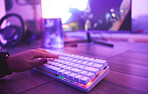 PC keyboard, gaming and hand for video game, online streaming and gamer room in neon light. Woman or person hands typing or press keys on gamer electronics, computer technology and rgb lights closeup