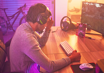 Buy stock photo Headache, gamer or man on computer with depression from loss, fail or online competition tournament anxiety in room. Neon, sad or male stress for gaming mental health, live stream or esport glitch