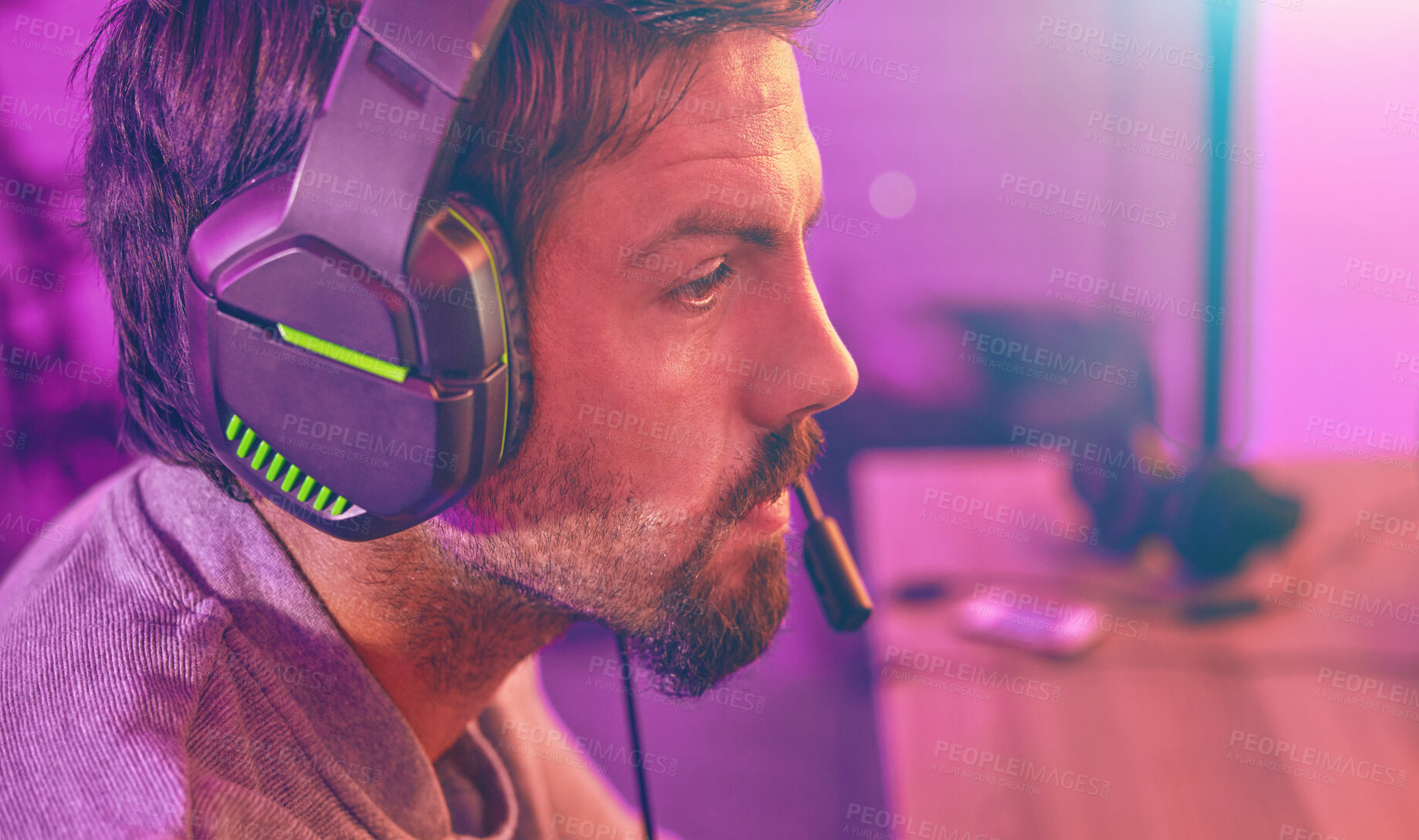 Buy stock photo Serious face, gamer or man with headphone focus on online competition, tournament or gaming in room. Neon, thinking or male geek for live internet stream, esports challenge or video game at night