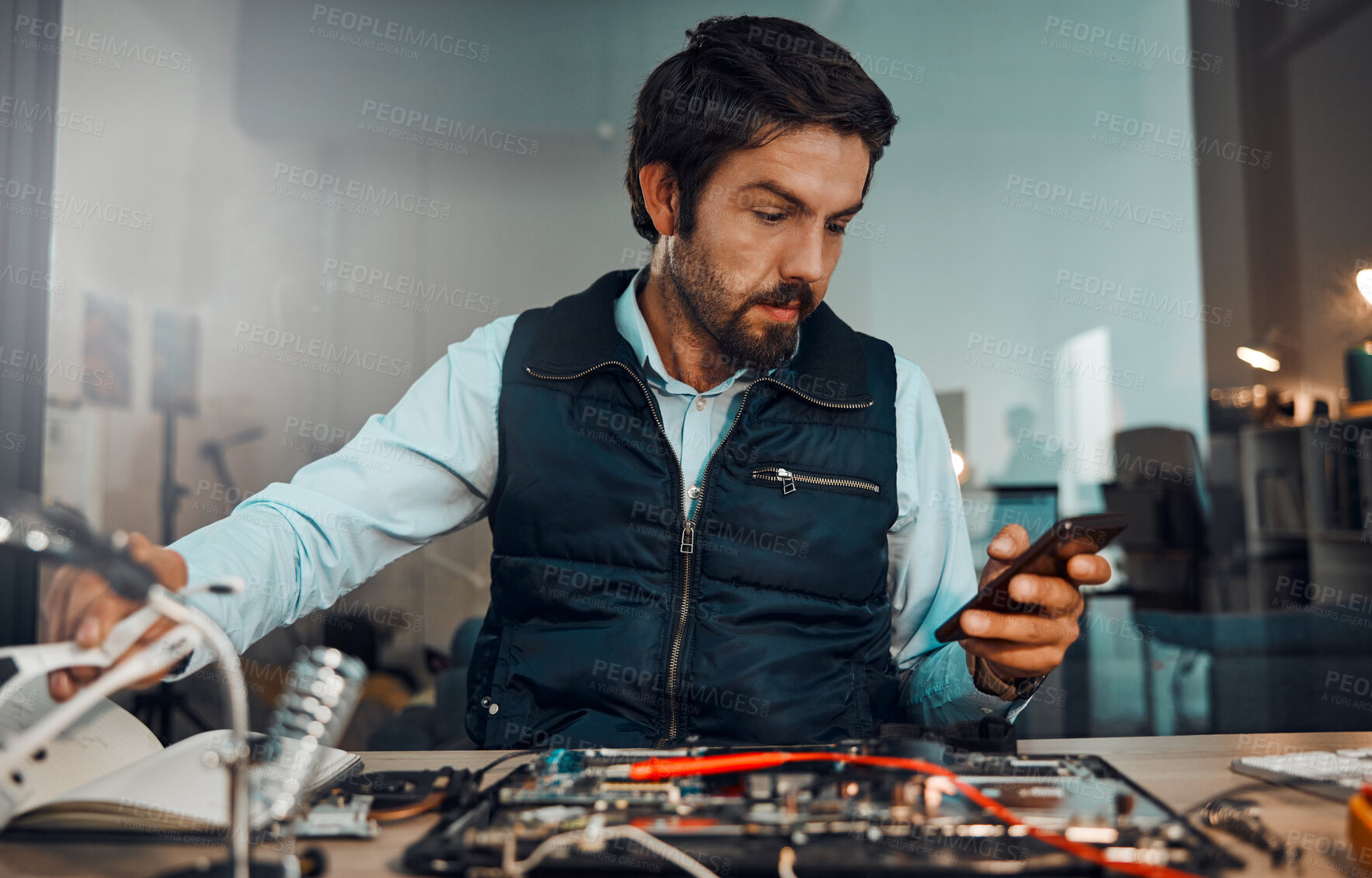 Buy stock photo Computer hardware repair, phone and it worker watch a diy video to fix a semiconductor and circuit. Engineering, workshop and electric work of a male engineer with a mobile doing electrical project