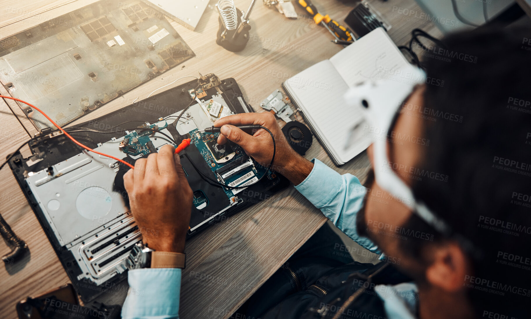 Buy stock photo Hardware, engineering and IT professional repair motherboard, microcircuit or electronic device in a workshop or shop. Overhead, man and guy fixing a computer for technology in a lab or factory