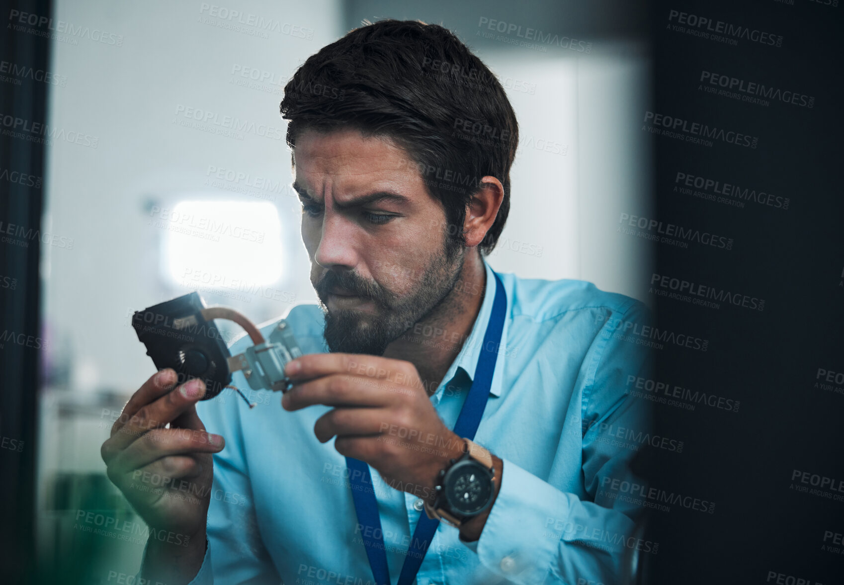 Buy stock photo Serious man, IT technician and electrical repair for hardware fixing, technology or problem solving at office. Focused male engineer or handyman holding electronic tech component for computer repairs
