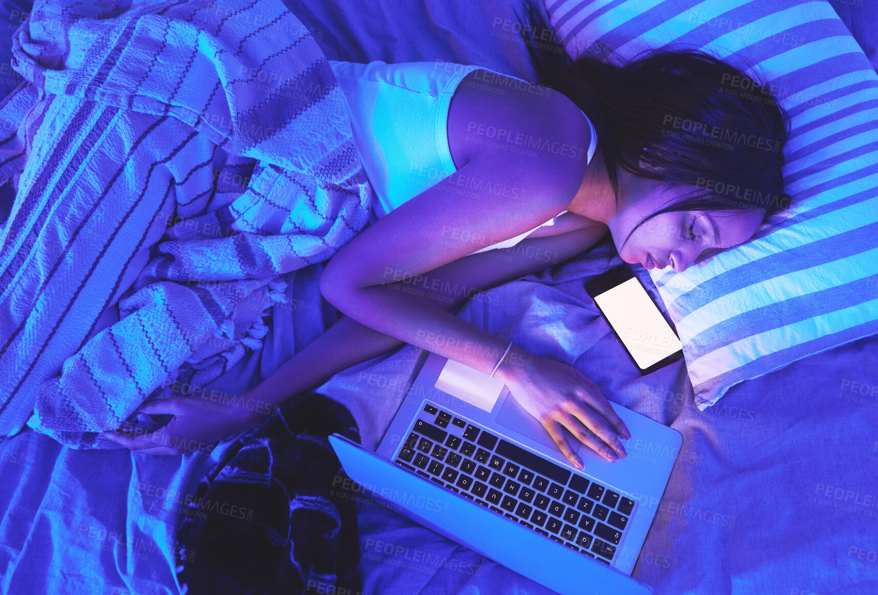 Buy stock photo Woman, night and technology while sleeping in home bed with light from laptop and phone in bedroom. Tired student person with burnout asleep online for remote work or mockup social media chat on top