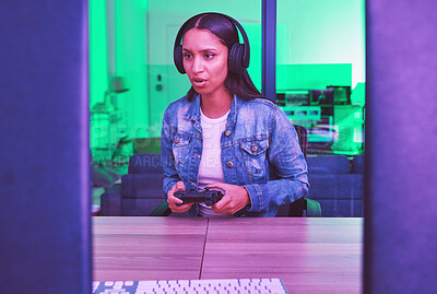 Buy stock photo Headphones, gamer and woman on computer in home at night in green neon light for web esports. Gaming, technology and female with controller playing online games, multiplayer or video game in house.