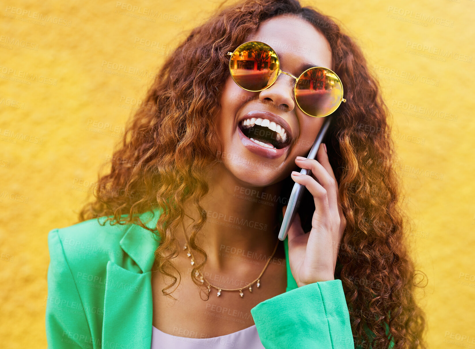 Buy stock photo Phone, talking and woman laughing with sunglasses on color background, yellow wall or backdrop. Happy trendy female, smartphone and communication with mobile technology, shades and contact networking