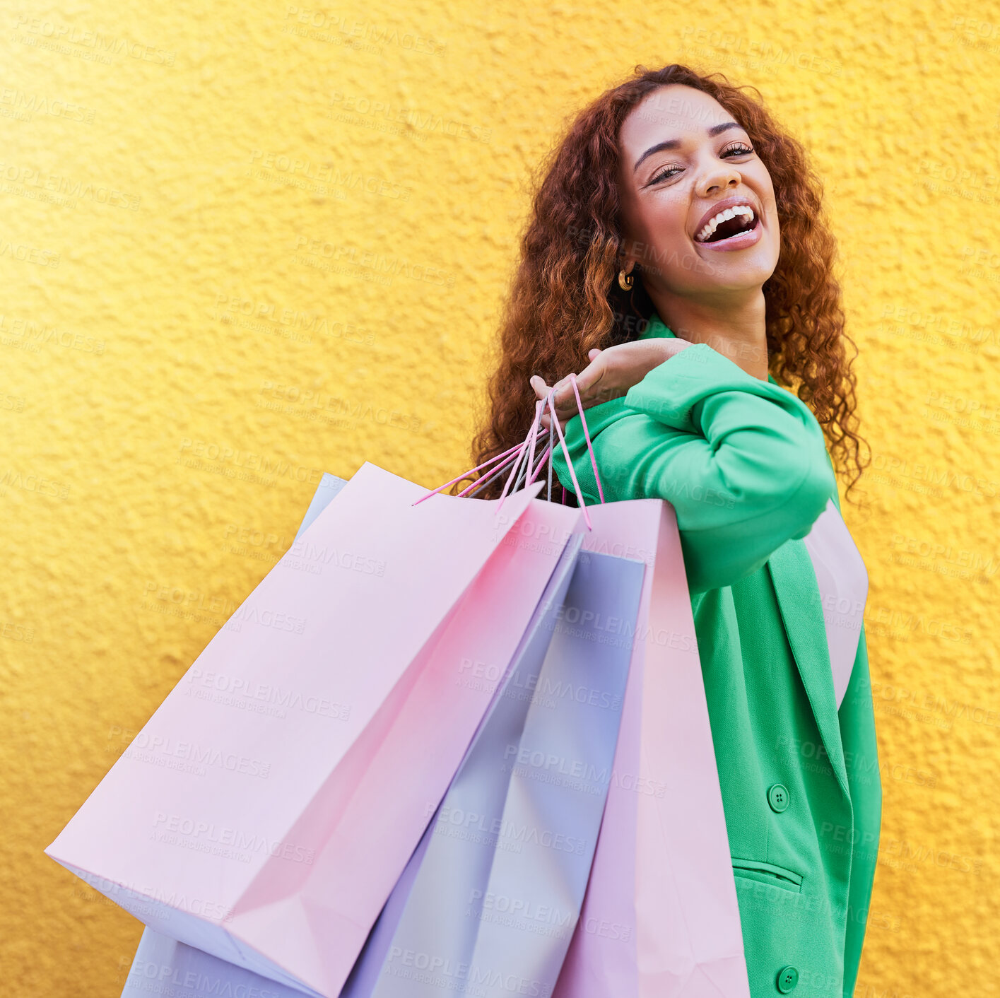 Buy stock photo Portrait, shopping bag and happy black woman with wealth, success or promotion sale isolated on wall background. Retail, fashion and excited, young funky model or customer person for discount clothes