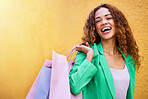 Shopping bag, portrait and black woman with beauty success, fashion sale or promotion isolated on wall background. Retail, wealth and excited funky model or person with clothes celebration mockup