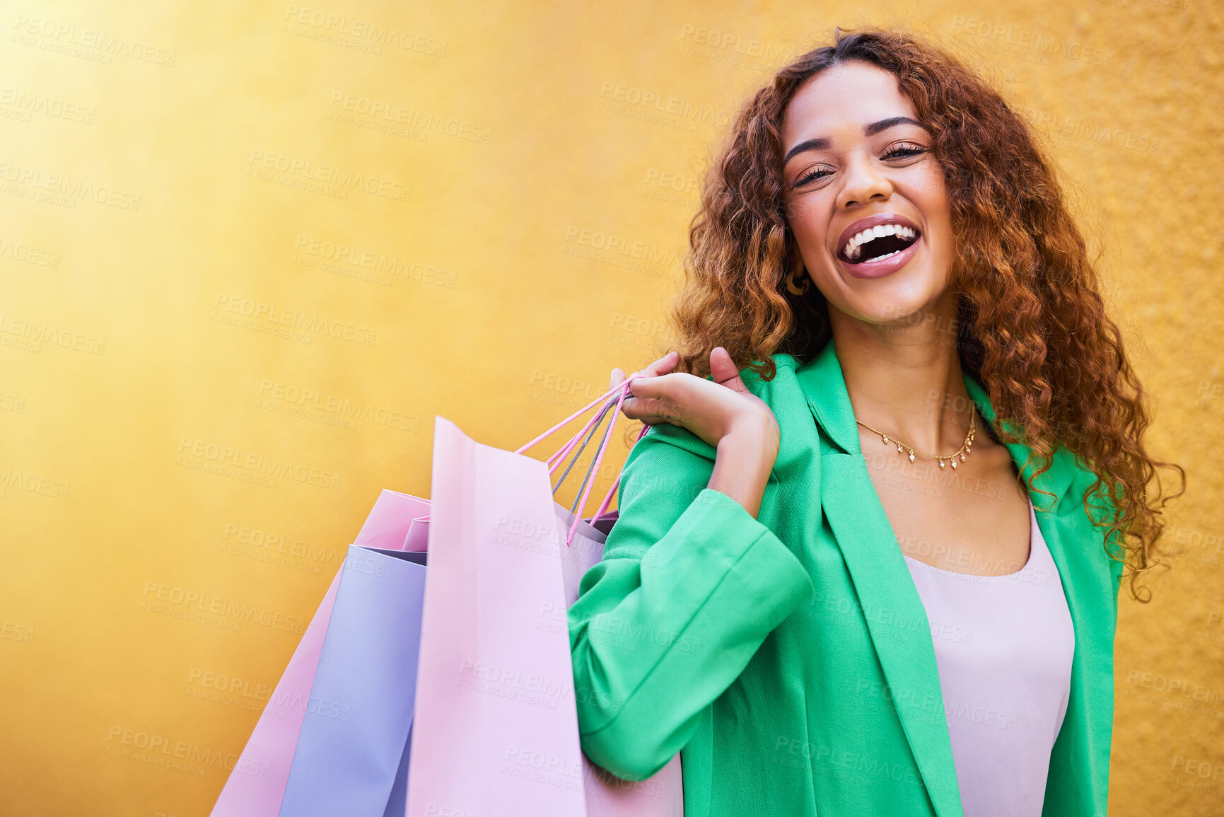 Buy stock photo Shopping bag, portrait and black woman with beauty success, fashion sale or promotion isolated on wall background. Retail, wealth and excited funky model or person with clothes celebration mockup