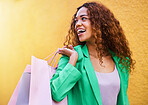 Shopping bag, fashion and black woman isolated on wall background with idea, vision and wealth success for sale. Retail, outdoor and funky model or young customer person walking with discount clothes