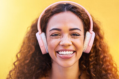 Buy stock photo Music, portrait and smile with a black woman listening to the radio outdoor on a yellow wall background. Headphones, energy and face with an attractive young female streaming audio sound for fun