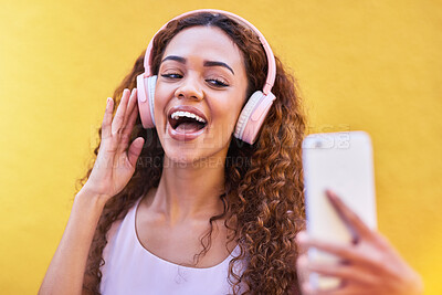 Buy stock photo Black woman, music headphones and selfie on yellow wall background for freedom. Face of happy gen z person with curly hair outdoor for listening and streaming audio for influencer post in Colombia