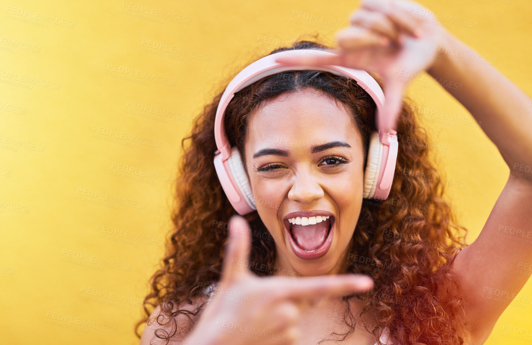 Buy stock photo Hands, frame and portrait of woman with headphones on yellow background for profile picture. Face, female and finger framing with music for perspective, selfie and vision of happiness, smile and tech