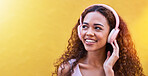 Music, thinking and mockup with a black woman listening to the radio outdoor on a yellow wall background. Headphones, energy and face with an attractive young female streaming audio sound for fun