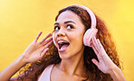 Music, freedom and wow with a black woman listening to the radio outdoor on a yellow wall background. Headphones, energy and face with an attractive young female streaming audio sound for fun