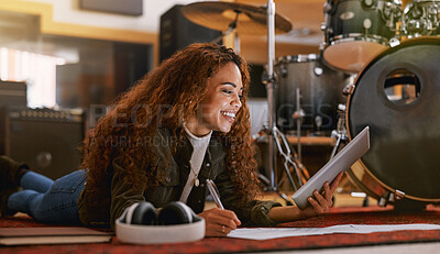 Buy stock photo Black woman, smile and tablet writing music in recording studio for audio track, content creation or development. Happy African female song writer smiling in lyrics holding touchscreen lying on floor