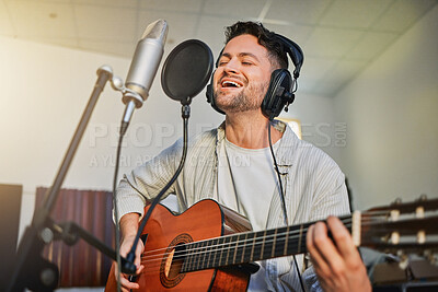 Buy stock photo Guitar, microphone and singing in studio for album recording, theatre label or radio musician industry. Man, singer and guitarist headphones for instrument production, theater sound or karaoke media