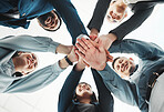 Business people, hands together and unity below for agreement, teamwork or collaboration at office. Low angle of group piling hand in team meeting, partnership or support and motivation at workplace