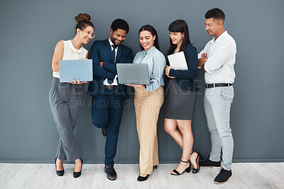 Buy stock photo Business, teamwork and laptop on wall background for planning, strategy or online data management. Happy group of employees working on computer, diversity collaboration or research website technology