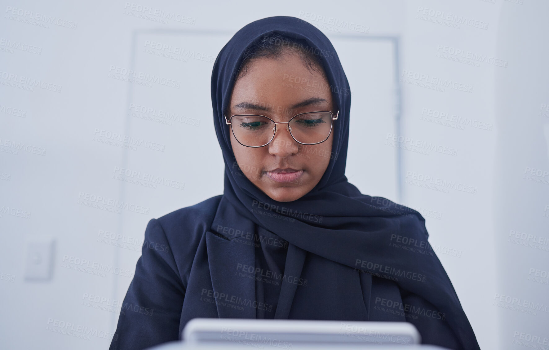 Buy stock photo Muslim, tablet working and hijab of a serious woman employee from Dubai writing code. Islam, web data and coding program of a it worker in a office planning with business software and analytics