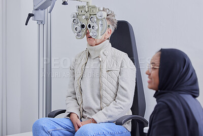 Buy stock photo Optometry, ophthalmology and Islamic optometrist in Dubai consulting a patient for an eye test using a Phoropter for vision. Eyesight, woman and Muslim person with hijab doing optical examination