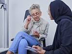 Optometry, healthcare and woman filling in a form before doing a eye test in a optic clinic. Health insurance, ophthalmology and optician helping senior female patient with document in optical store.