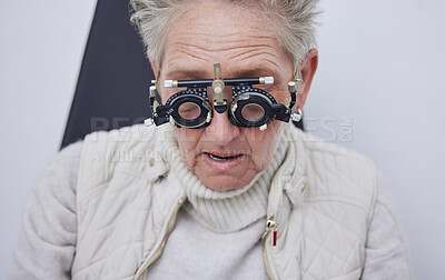 Buy stock photo Eye exam, trial frame and senior woman in optometry clinic for vision test, eyesight and optical assessment. Ophthalmology, health and face of elderly patient with optician, optometrist and glasses