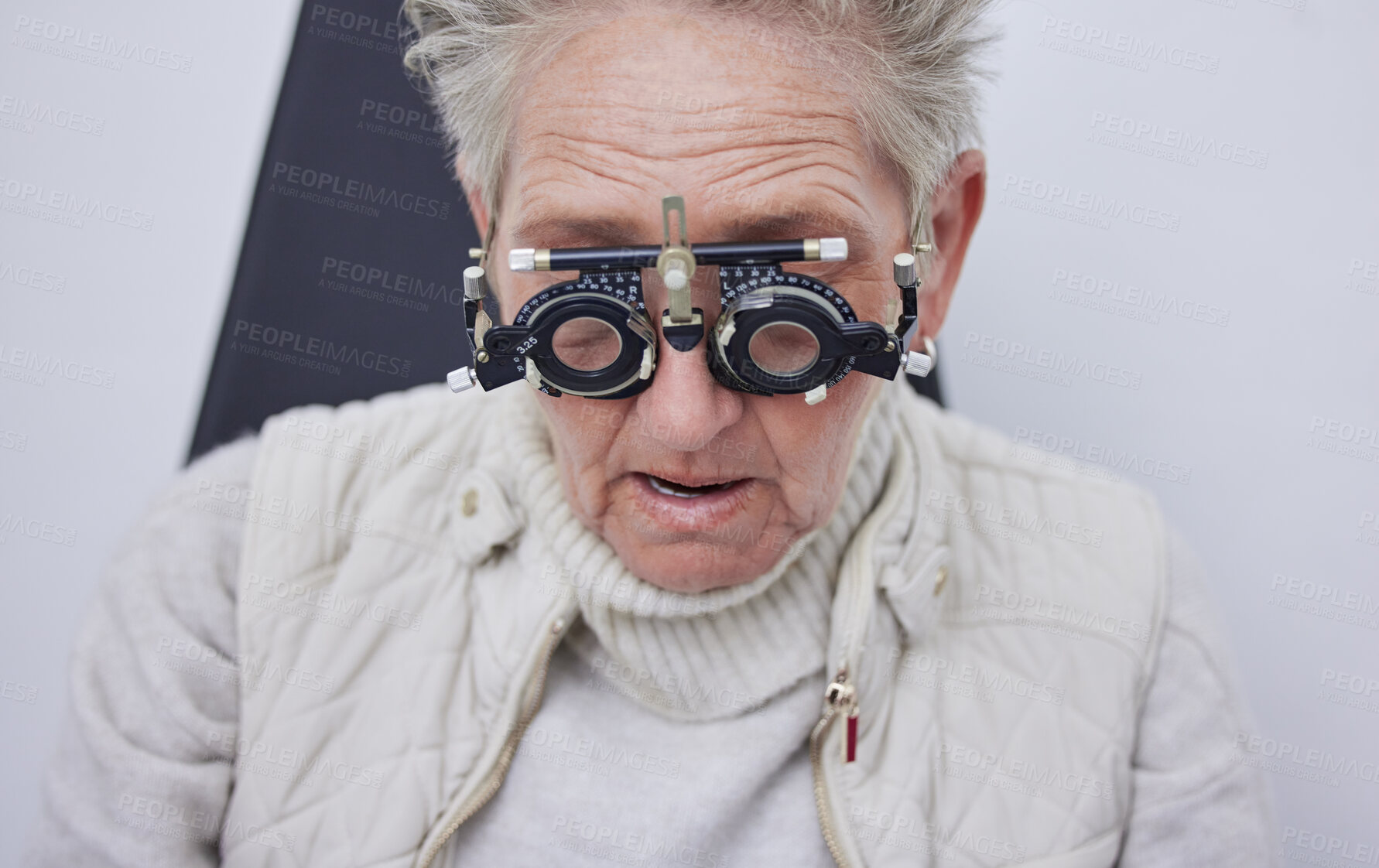 Buy stock photo Eye exam, trial frame and senior woman in optometry clinic for vision test, eyesight and optical assessment. Ophthalmology, health and face of elderly patient with optician, optometrist and glasses