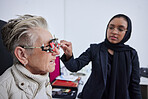 Eye exam, frame and senior woman with optometrist in clinic for vision test, eyesight and optical assessment. Optometry, healthcare and Muslim optician with patient, trial lens and medical eyeglasses