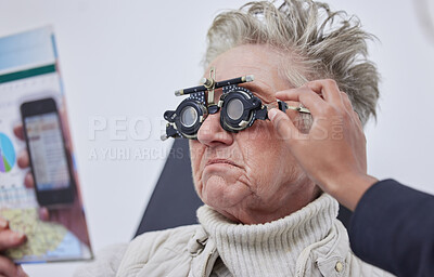 Buy stock photo Vision, trial frame and woman for eye exam in optometry clinic for test, eyesight and optical assessment. Ophthalmology, health and elderly patient reading with optician, optometrist and glasses