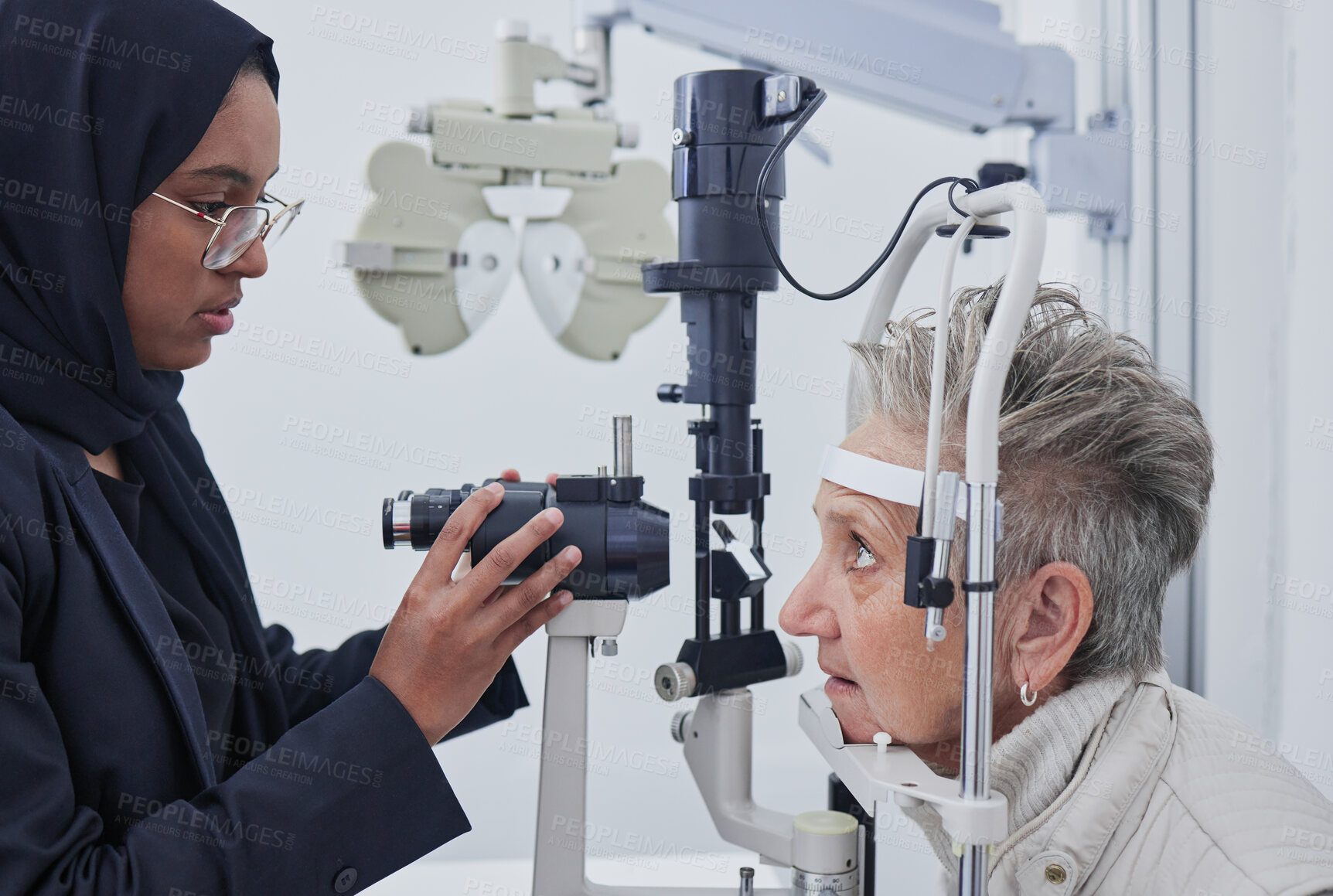 Buy stock photo Eye exam, optometrist and senior woman in clinic for test, eyesight and ophthalmology assessment. Optometry, optical healthcare and Muslim optician with patient for testing, medical lens and glasses