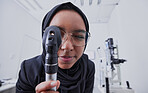 Vision, optometrist and woman with retinoscope in hospital for examination. Eye test, healthcare and muslim doctor or ophthalmologist with equipment tool for eyecare, health and wellness in clinic.