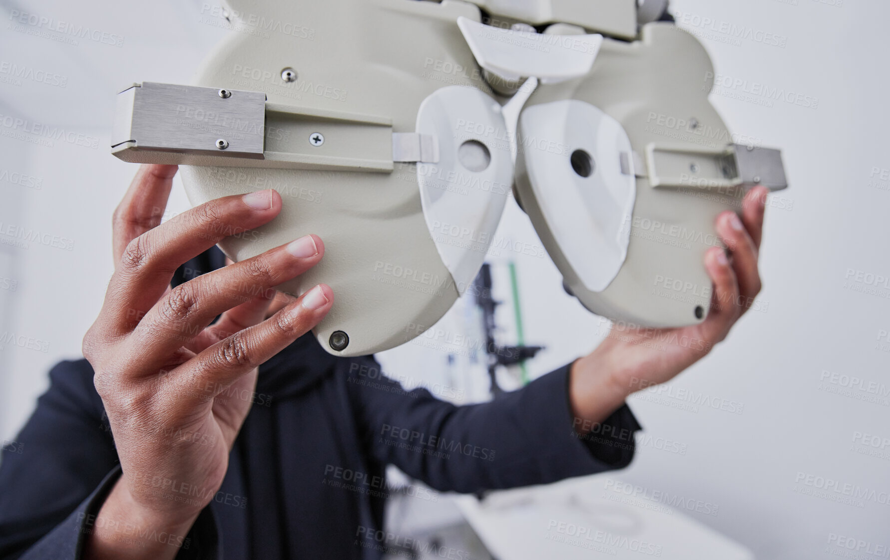 Buy stock photo Optometry, machine and optometrist preparing for a eye test in the optic or healthcare clinic. Vision, ophthalmology and hands of a female optician with optical equipment for a exam in a store.