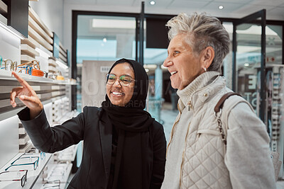 Buy stock photo Decision, glasses and senior woman with an optician for help with eyewear and shopping for a frame. Consulting, talking and Muslim employee helping an elderly patient with choice of eyeglasses