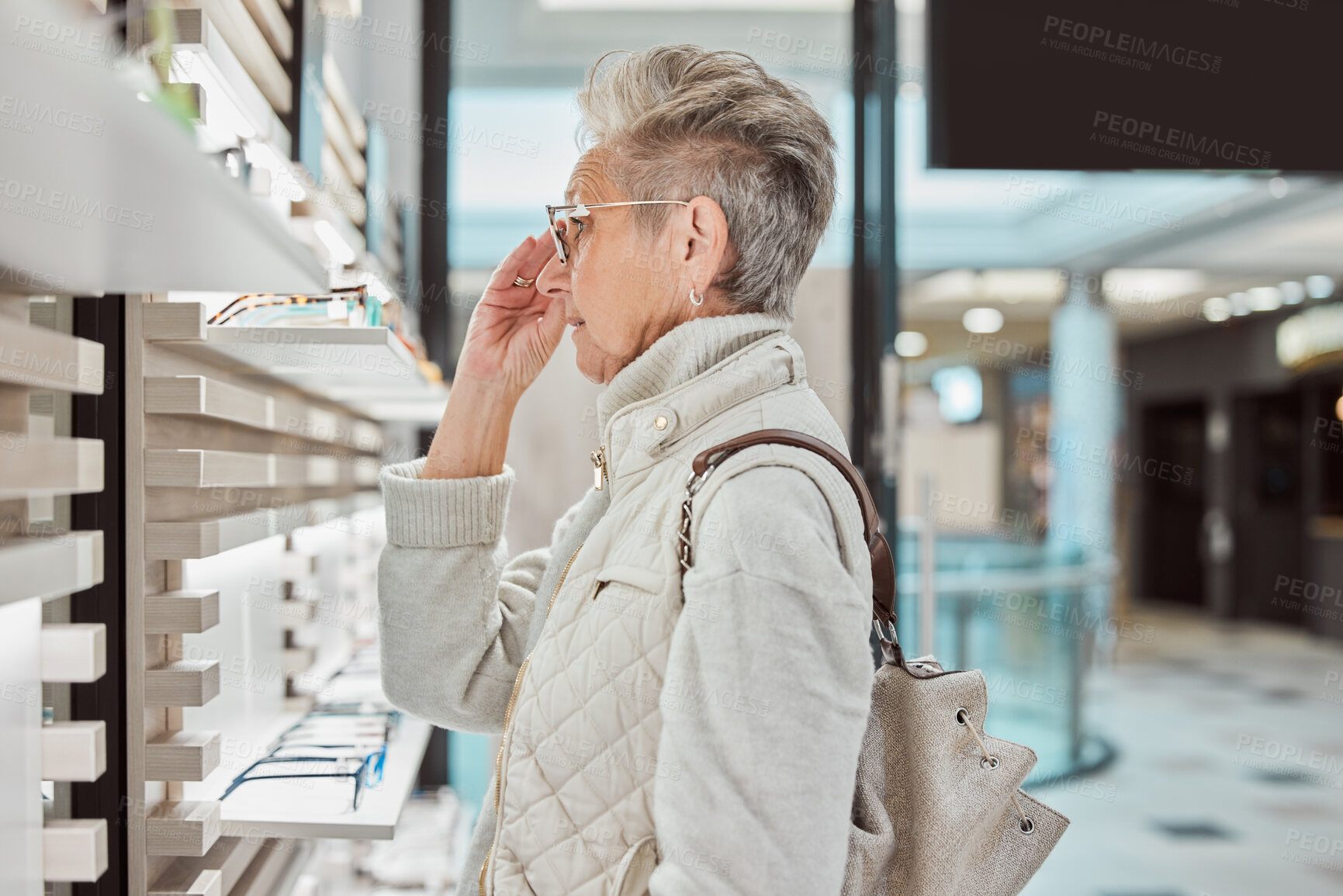 Buy stock photo Fashion, retail and glasses with a senior woman customer in an eyewear store for new frame spectacles. Healthcare, vision and shopping with a mature female consumer buying prescription lenses