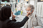 Optometry, Islamic woman and customer in store, glasses and healthcare for vision, retail an testing. Optometrist, mature female and Muslim lady help client, eyewear and optician with frames or sales