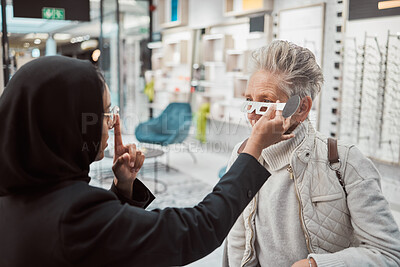 Buy stock photo Optometry, Islamic woman and customer in store, glasses and healthcare for vision, retail an testing. Optometrist, mature female and Muslim lady help client, eyewear and optician with frames or sales