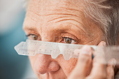 Buy stock photo Eyes, vision and healthcare with a senior woman testing her eyesight for prescription lenses for focus. Medical, blind and consulting with a female patient at the optician to measure for glasses