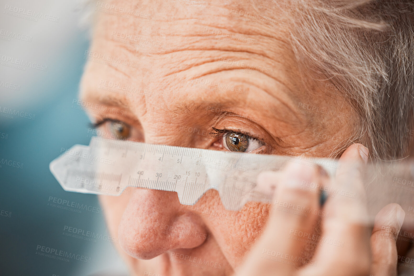 Buy stock photo Eyes, vision and healthcare with a senior woman testing her eyesight for prescription lenses for focus. Medical, blind and consulting with a female patient at the optician to measure for glasses