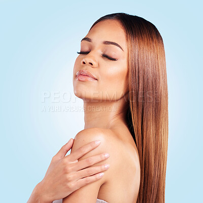 Buy stock photo Skincare, hair care and woman with a glow from grooming isolated on a blue background in a studio. Dermatology, health and girl with self love, care for body and morning routine on a backdrop