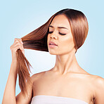 Face, beauty and hair loss of sad woman in studio isolated on a blue background. Hairloss, haircare and unhappy female model with hairstyle problem, split ends and damage  after salon treatment.