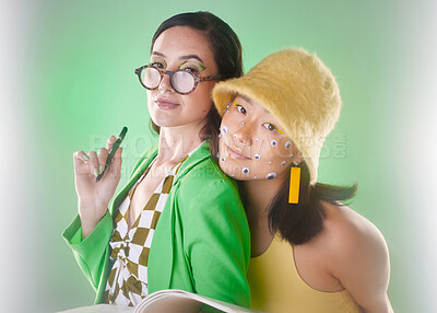 Buy stock photo Portrait, gen z and and books with woman friends in studio on a green background for fashion or education. Beauty, cosmetics and friendship with people posing for modern or contemporary neon style